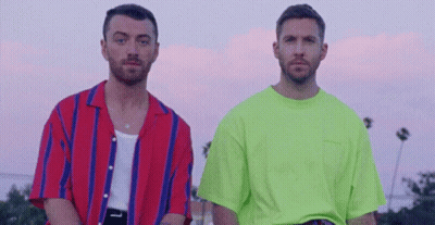Two Men Standing In Front Of Palm Trees GIF
