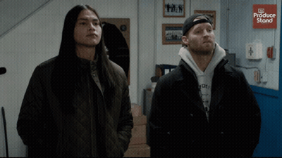 Two Men Standing In Front Of Produce Store GIF