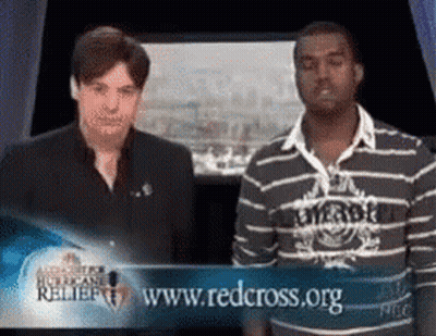Two Men Standing In Front Of Red Cross Sign GIF