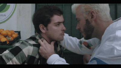Two Men Standing In Front Of Ria Sign GIF