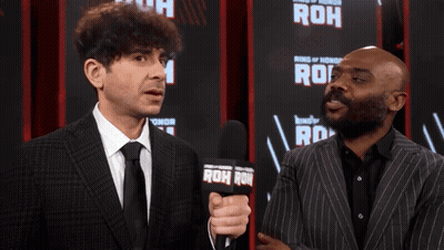 Two Men Standing In Front Of Ring Of Honor Sign GIF