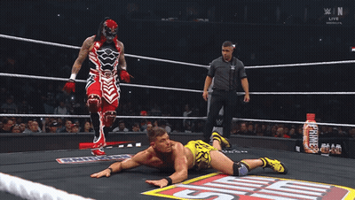 Two Men Standing In Front Of Sign Saying AEW Hey GIF