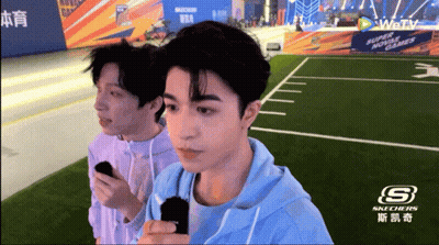 Two Men Standing In Front Of Skechers GIF