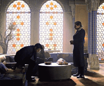 Two Men Standing In Front Of Stained Glass Window GIF