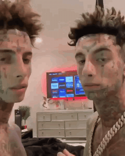 Two Men Standing In Front Of Television GIF