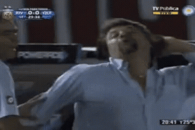 Two Men Standing In Front Of TV Publica GIF
