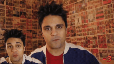 Two Men Standing In Front Of Wall With Pictures Number 3 GIF