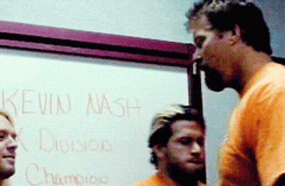 Two Men Standing In Front Of White Board Saying Kevin Nash GIF