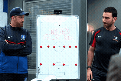 Two Men Standing In Front Of Whiteboard Saying Nates False War GIF