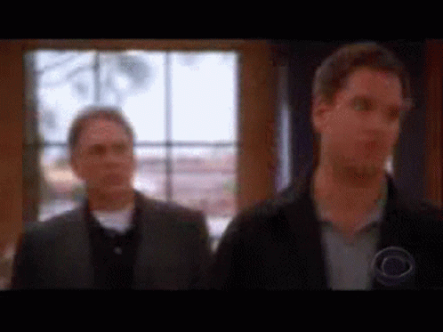 Two Men Standing In Front Of Window GIF
