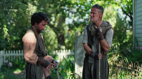 Two Men Standing In Garden GIF