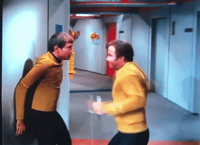 Two Men Standing In Hallway GIF