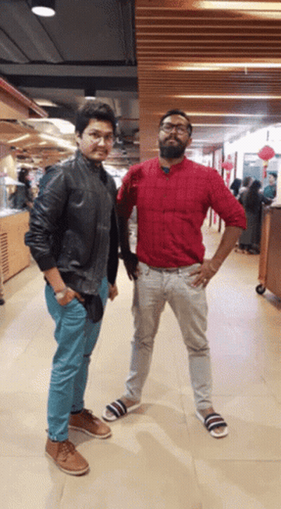 Two Men Standing In Hallway GIF
