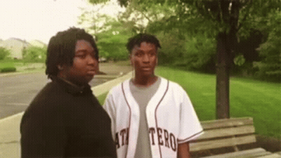 Two Men Standing In Park GIF