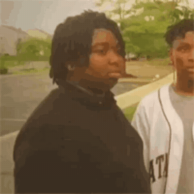 Two Men Standing In Parking Lot GIF