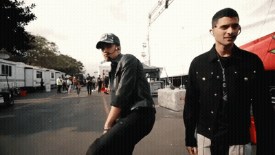 Two Men Standing In Parking Lot GIF