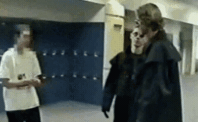 Two Men Standing In School Hallway GIF