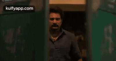 Two Men Standing Near Door GIF