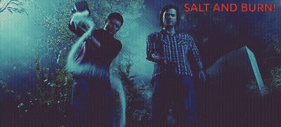 Two Men Standing Next To A Grave With The Words Salt And Burn GIF