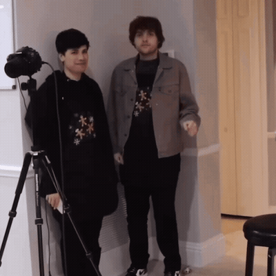 Two Men Standing Next To Camera GIF