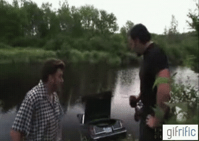Two Men Standing Next To Car In River With Trunk Open GIF