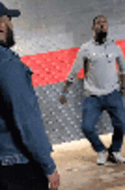 Two Men Standing Next To Each Other GIF