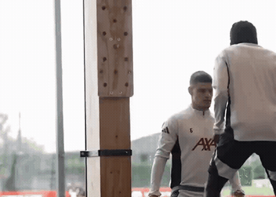 Two Men Standing Next To Each Other GIF