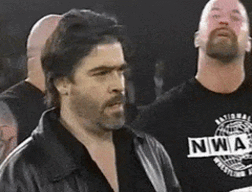 Two Men Standing Next To Each Other GIF