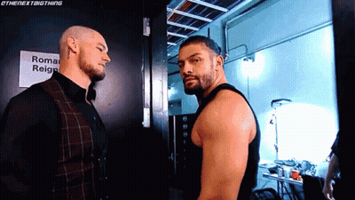 Two Men Standing Next To Each Other GIF