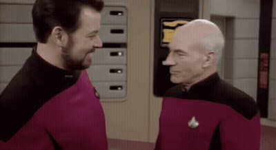 Two Men Standing Next To Each Other GIF