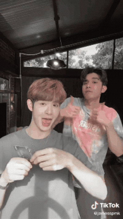 Two Men Standing Next To Each Other GIF