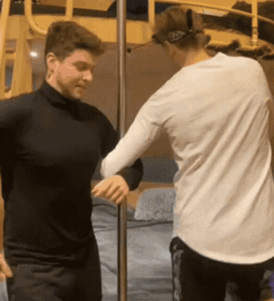 Two Men Standing Next To Each Other GIF