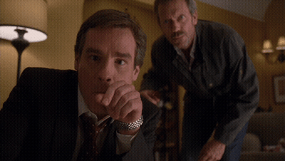Two Men Standing Next To Each Other GIF