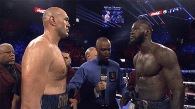 Two Men Standing Next To Each Other In A Boxing Ring With Coca Cola Advertisements On The Screen GIF