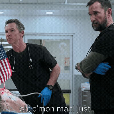 Two Men Standing Next To Each Other In A Hospital Room With The Words Ohc Mon Man Just Above Them GIF