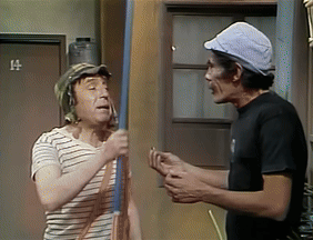 Two Men Standing Next To Each Other In Front Of A Door With The Number 14 On It GIF