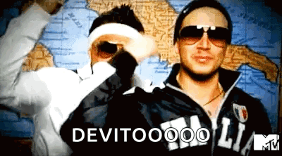 Two Men Standing Next To Each Other In Front Of A Map With The Words Devitooo On The Bottom GIF