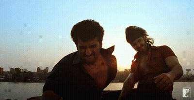 Two Men Standing Next To Each Other In Front Of A Sunset GIF