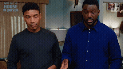 Two Men Standing Next To Each Other In Front Of A Wall That Says Tyler Perry 'S House Of Payne GIF