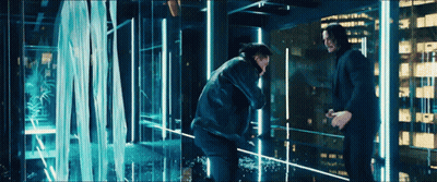 Two Men Standing Next To Each Other In Front Of A Waterfall . GIF
