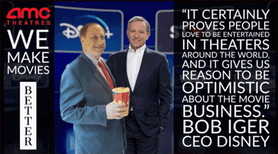 Two Men Standing Next To Each Other In Front Of An Amc Theatres Sign GIF