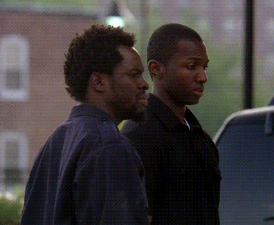 Two Men Standing Next To Each Other In Front Of Window GIF