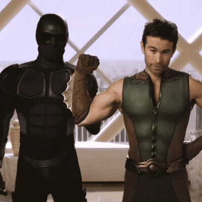 Two Men Standing Next To Each Other In Front Of Window GIF