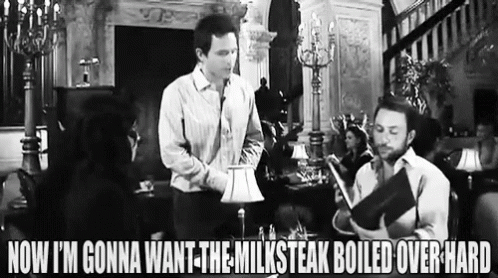 Two Men Standing Next To Each Other In Living Room GIF