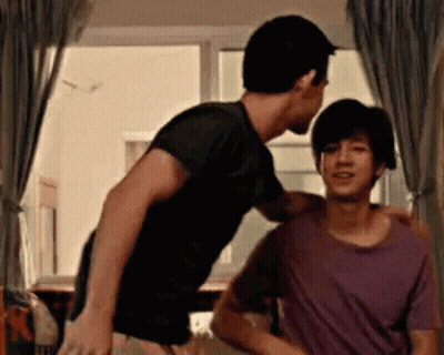 Two Men Standing Next To Each Other In Room GIF