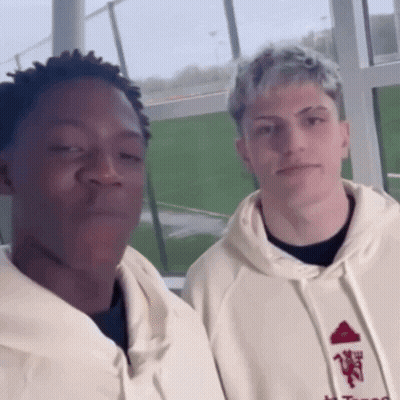 Two Men Standing Next To Each Other GIF