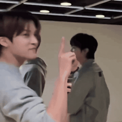 Two Men Standing Next To Each Other One Giving Middle Finger GIF