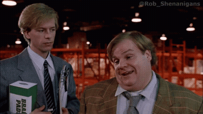 Two Men Standing Next To Each Other One Holding A Box Of Brad Pads GIF