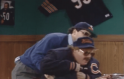 Two Men Standing Next To Each Other One In Bear Jacket GIF