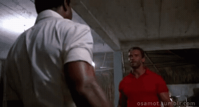 Two Men Standing Next To Each Other One In Red Shirt GIF